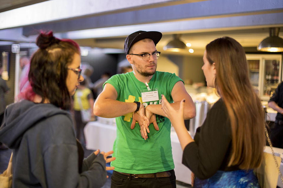 Two people are deep in discussion at a creative event.