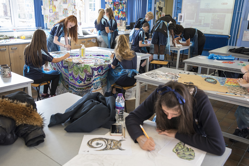 A group of students working in an art room.