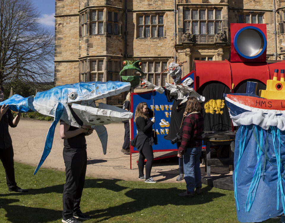Young people and creatives are pictured in front of Gawthorpe Hall in Padiham. They have created large and colourful models, one represents a ship called HMS Liverpool and one is a whale.