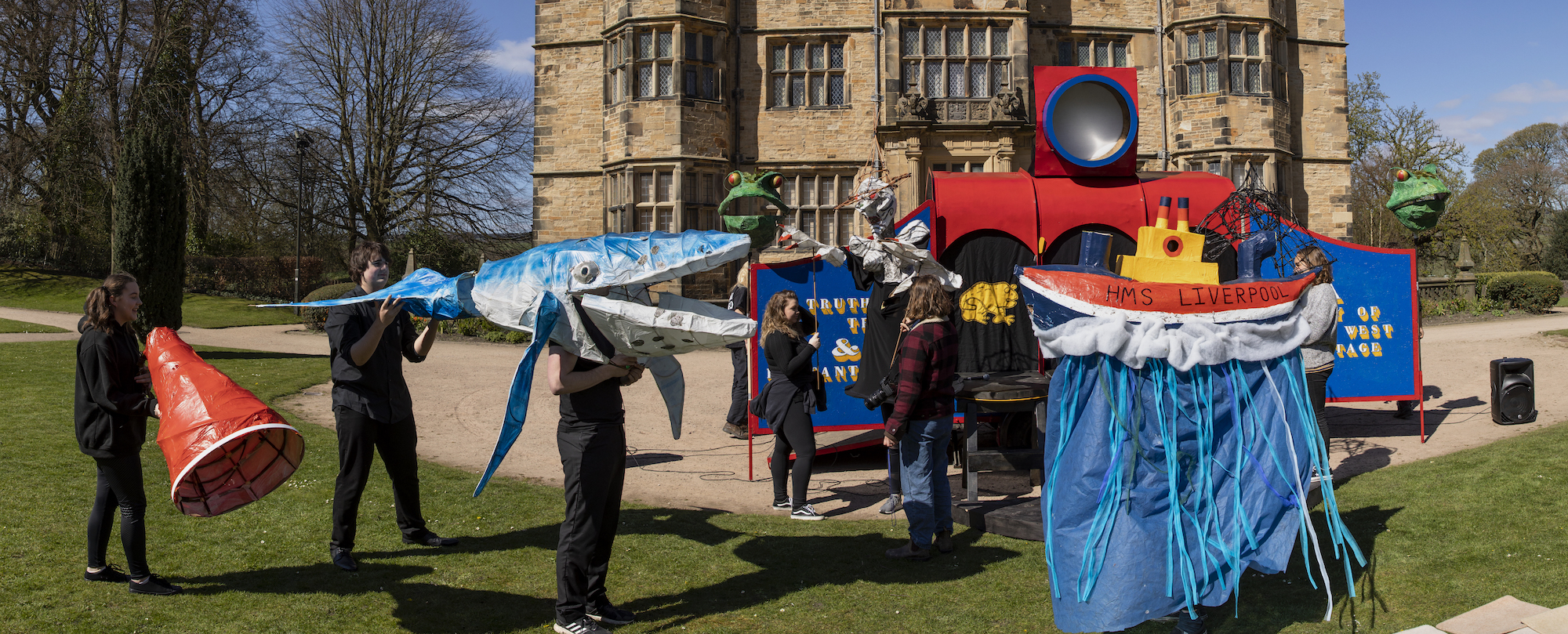 Young people and creatives are pictured in front of Gawthorpe Hall in Padiham. They have created large and colourful models, one represents a ship called HMS Liverpool and one is a whale.