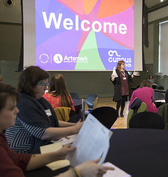 Emma Bush addressing the Curious Minds Schools Arts Festival