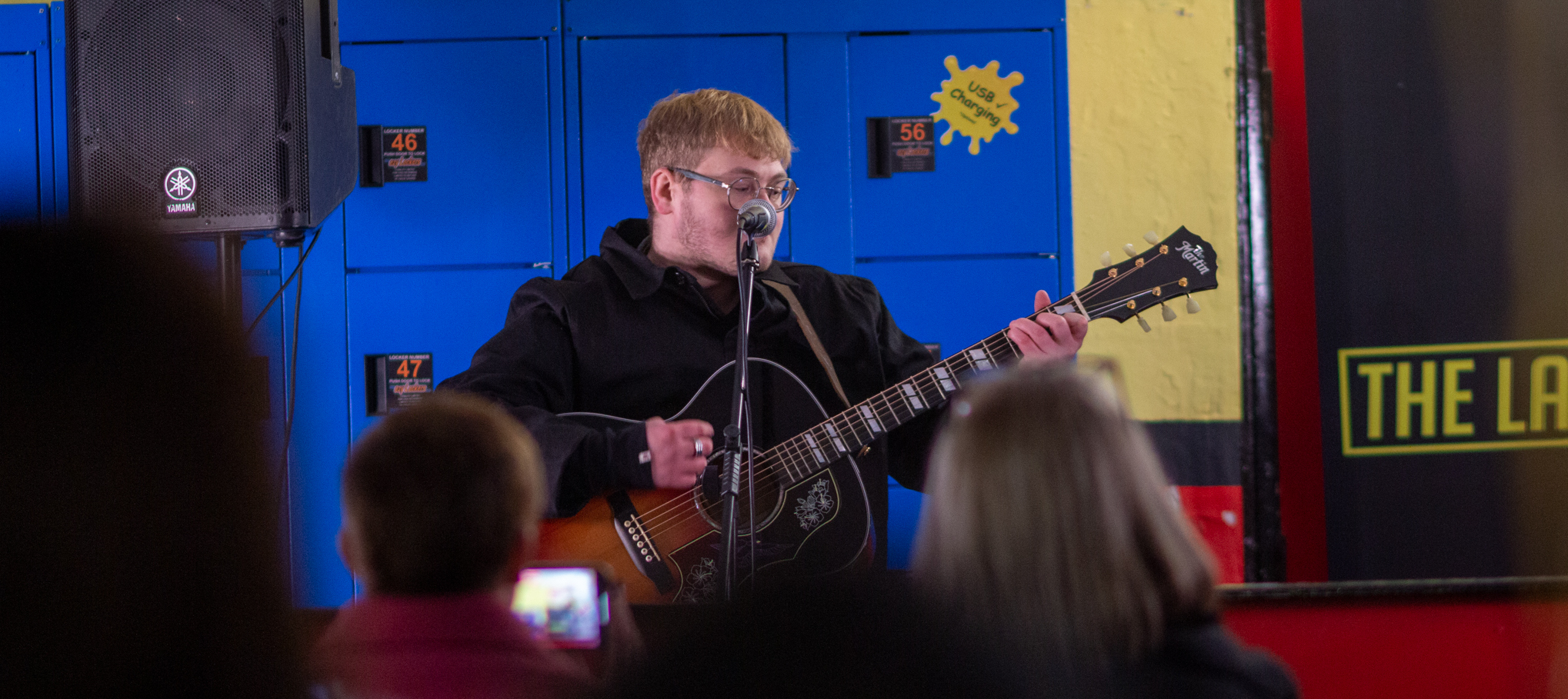 Singer/songwriter and guitarist in The Lathams, Alex Moore, plays for young people at the Chance to See Fund launch event.