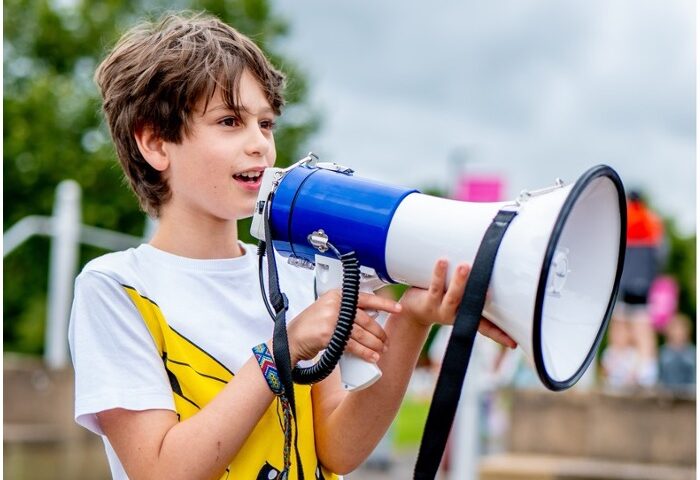 A child speaking into a megaphone